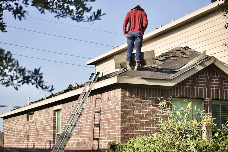 Professional roofer working on a residential roof in Laguna